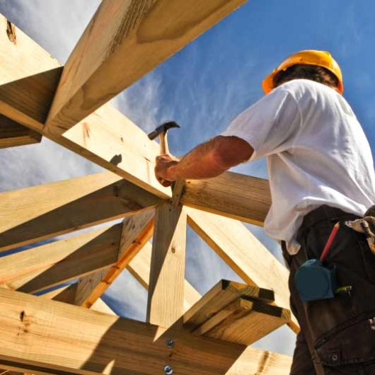 Builder working on roof structure